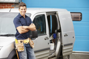 Plumber Or Electrician Standing Next To Van